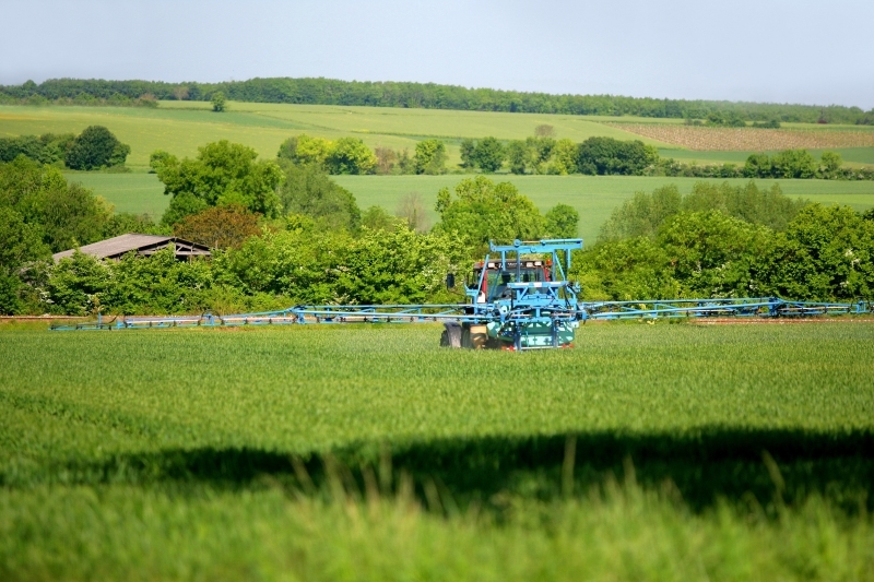 Crop spraying with a tractor. Credits: Phovoir/, 2010.
